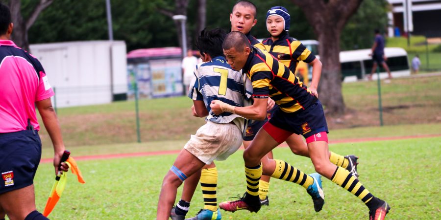 Boys playing rugby with mouthguards protecting their teeth and orthodontic treatment