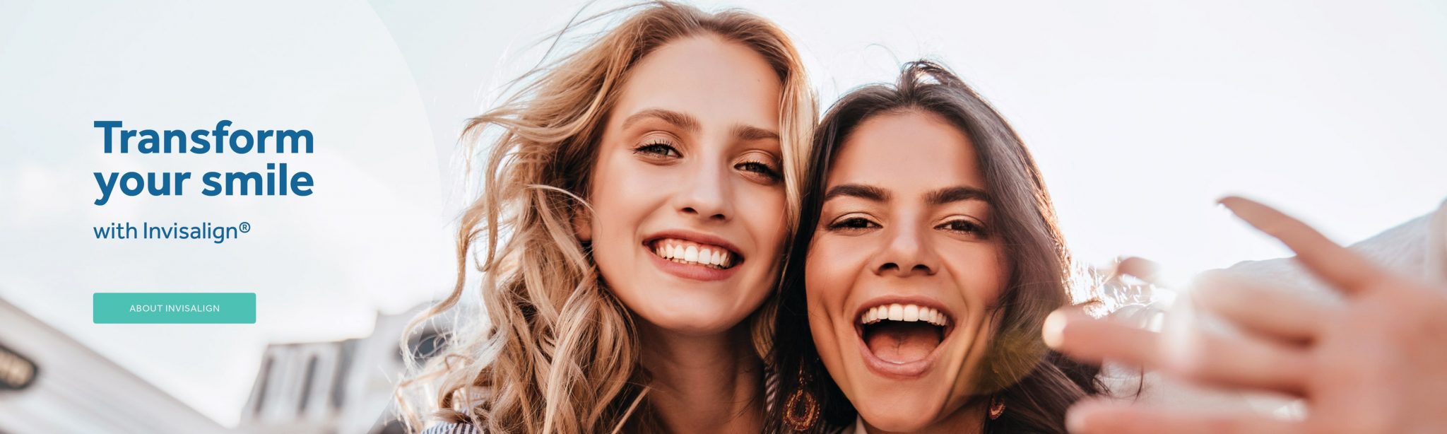 Two girls smiling with white and straight teeth after Invisalign treatment at Toowong Orthodontics